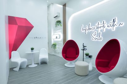 Interior lounge of The Smile Bar Molito Alabang branch with modern whitening chairs