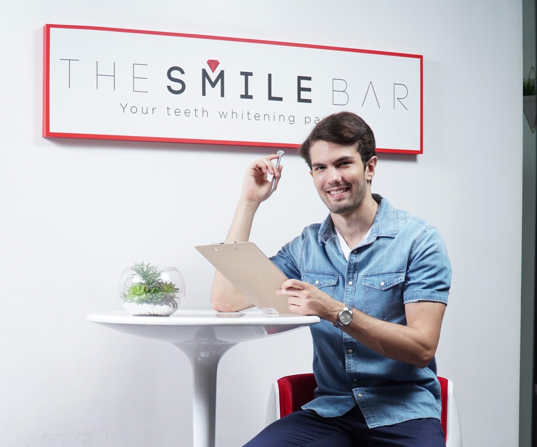A man sitting at The Smile Bar Philippines during a professional LED teeth whitening consultation.